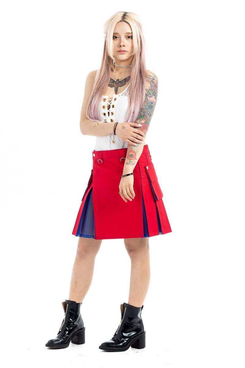 Front view of red hybrid kilt with navy net pleats worn with lace-up top