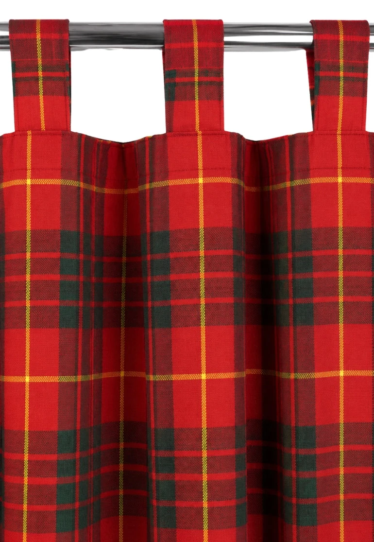 Red tartan tab top curtains with green and yellow lines hanging on a metal rod