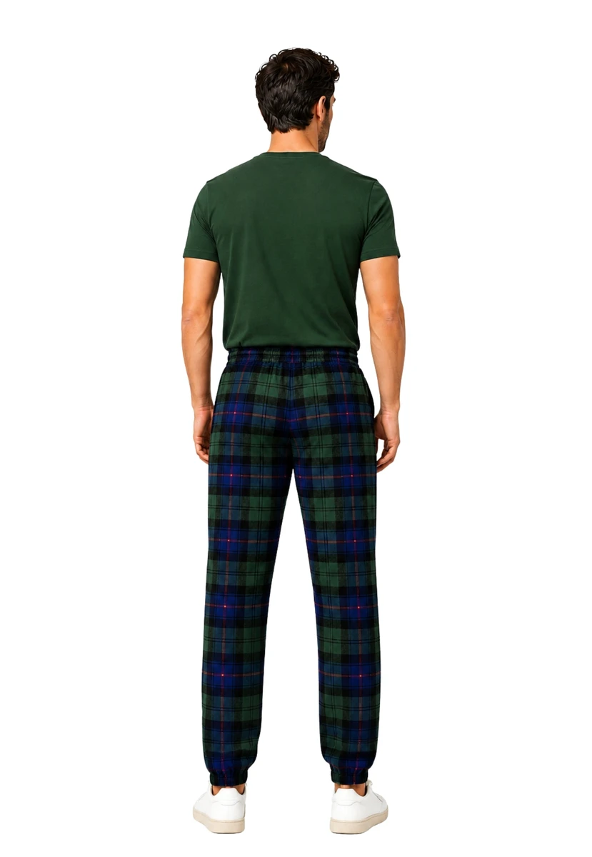 Man in navy and green tartan trousers with a green T-shirt, back view