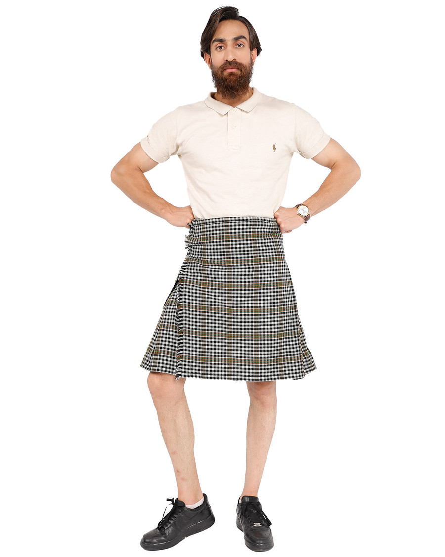 Man wearing a bespoke kilt in red and navy tartan with a beige polo shirt, front view