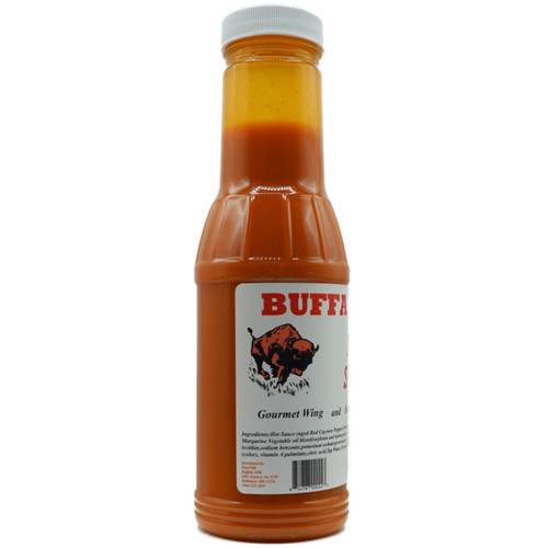 Buffalo Gill's Mild Sauce 12 oz bottle back view featuring the Buffalo Gills brand logo with a charging bison, full ingredients list, and distributor information for Paul Gill in Baltimore, MD.