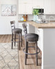 Caitbrook - Tall UPH Swivel Barstool - Gray