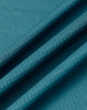 A close-up of teal jacquard knit fabric, displaying its textured surface and folds. The fabric has a subtle pattern.