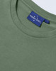 A green premium cotton ladies' short sleeve t-shirt with a label on the neckline.