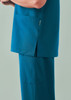 A pair of unisex straight leg scrub pants in teal, featuring side pockets and a simple design.