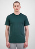 A plain green men's short sleeve tee, displayed on a model, paired with grey trousers. The shirt has a subtle logo.
