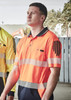 Men's short sleeve polo in high visibility orange with segmented reflective tape and a logo on the chest.