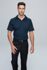 A model wearing a navy polo shirt paired with black trousers, featuring a logo on the shirt.