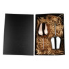A stainless steel wine glass gift set in rose gold and silver, presented in a black box with straw filling.