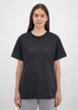 A black women's short sleeve tee is displayed on a model, featuring a simple design and relaxed fit.
