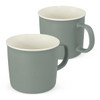 A drink mug set in muted green with cream interior, featuring a simple handle and a smooth finish.