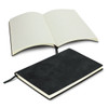 A black soft cover notebook opened to reveal lined pages, with a placeholder ribbon and a logo on the cover.