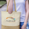 A cream tote bag with a contrasting brown bottom section, featuring a logo on the front.