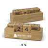 A bamboo desk calendar featuring engraved wooden blocks for days, months, and dates, with a white logo.