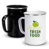 A set of enamel mugs in black and white, featuring a green apple design on the white mug and a handle.