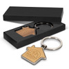 A house-shaped key ring with a wooden centre and a silver metal keyring, presented in a black gift box.