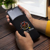 A black phone pouch is being held, featuring a logo and designed to fit a mobile device.
