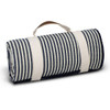 A rolled-up picnic blanket featuring navy blue and cream stripes, secured with a cream strap and handle.