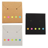 A set of three envelope-style pouches in brown, black, and white, each with colourful dot accents.