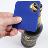 A drink bottle opener coaster in blue, being held above a bottle, featuring a logo on the bottle.