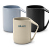 A reusable coffee cup set in light blue, black, and cream, featuring a handle and a branding logo.