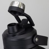 A drink bottle in black with a stainless steel lid and a removable cap, featuring a sturdy handle.