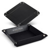 A black leather valet tray with silver snap fasteners and a branded interior.