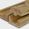A bamboo sushi maker featuring two interlocking pieces, showcasing a smooth, natural finish. It includes a small handle.