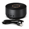 A wireless charging speaker in black with a gold accent, accompanied by a USB cable.