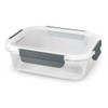 A glass lunch box with a transparent lid and grey clips for secure sealing. Suitable for storing meals.