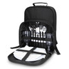 A black picnic backpack with cutlery, wine glasses, napkins, and plates neatly arranged inside.