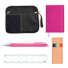 A black zippered pouch, a pink notebook, a pink pen, a colorful ruler, and a box of colored pens.