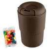 A brown reusable coffee cup with a ribbed texture, accompanied by a packet of colourful jelly beans.
