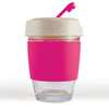A reusable coffee cup with a clear body, pink silicone band, and a light-colored lid featuring a straw.