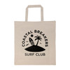 A cream-colored tote bag with a black logo featuring a palm tree, surfboard, and birds. It has short handles.