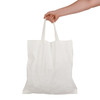 A hand holding a white short handle bamboo tote bag. The bag features two sturdy handles.
