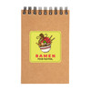 A spiral-bound notebook in brown with a vibrant ramen-themed design on the cover.