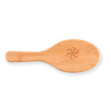 A bamboo hair brush with an engraved logo on the handle.