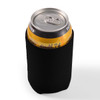 A drink can is held in a black stubby cooler, designed to keep beverages cold.