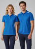 A short sleeve polo shirt in bright blue, featuring white accents and a logo, displayed by a male and female model.