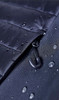 A close-up of a black soft shell jacket featuring a zip and water droplets on its surface.
