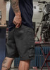 Men's rugged shorts in dark grey with utility pockets, featuring a logo on the side and a fitted design.
