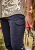 Men's lightweight outdoor cargo pants in navy blue, featuring side pockets and a logo. A hand holds pruning shears.