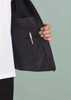 A black vest featuring an inner pocket with a pen holder, showcased against a muted background.