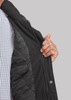 A black jacket with a zip and quilted lining, partially opened to reveal the interior. It features a logo.