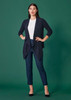 A model wearing navy mid-waist slim leg pants paired with a white top and a navy cardigan against a green background.