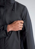 A black rain jacket with a zippered pocket on the sleeve, highlighting a hand reaching for the pocket.