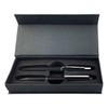 A metal pen gift set in a black box, featuring two black pens with silver accents and a logo.