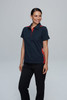 A navy polo shirt with red accents, featured on a smiling woman wearing black pants. The shirt has a logo on it.