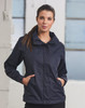 A navy versatile jacket featuring a hood and side pockets, modelled by a woman against an industrial backdrop.